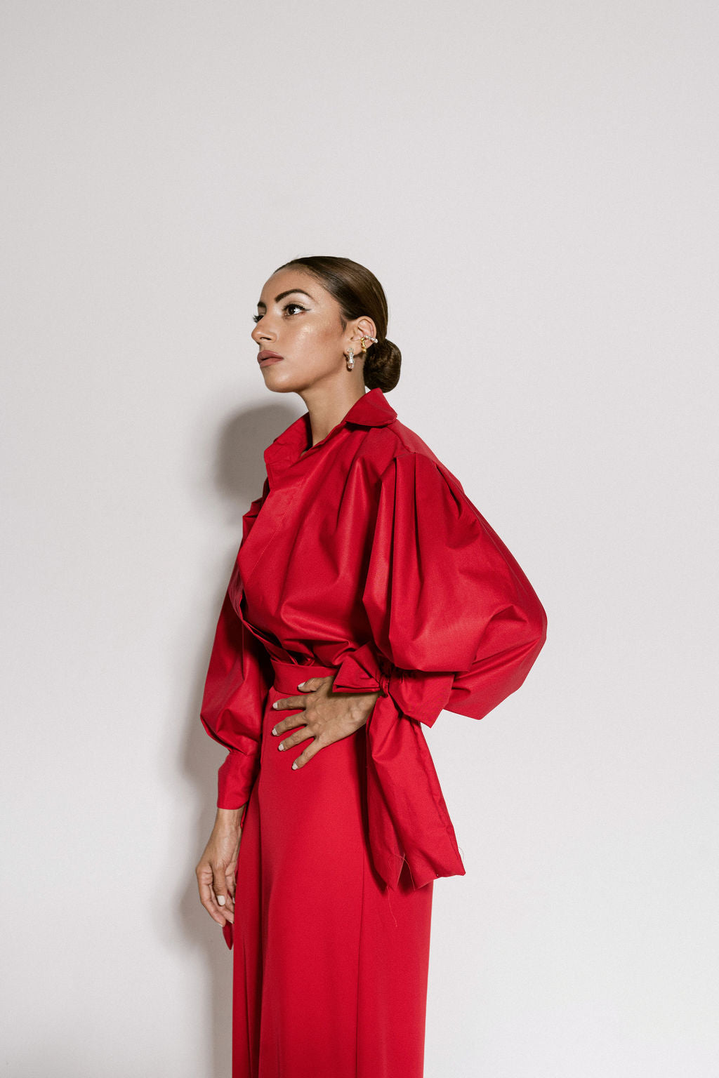 A model wearing red flowy pants by Monica Arguedas