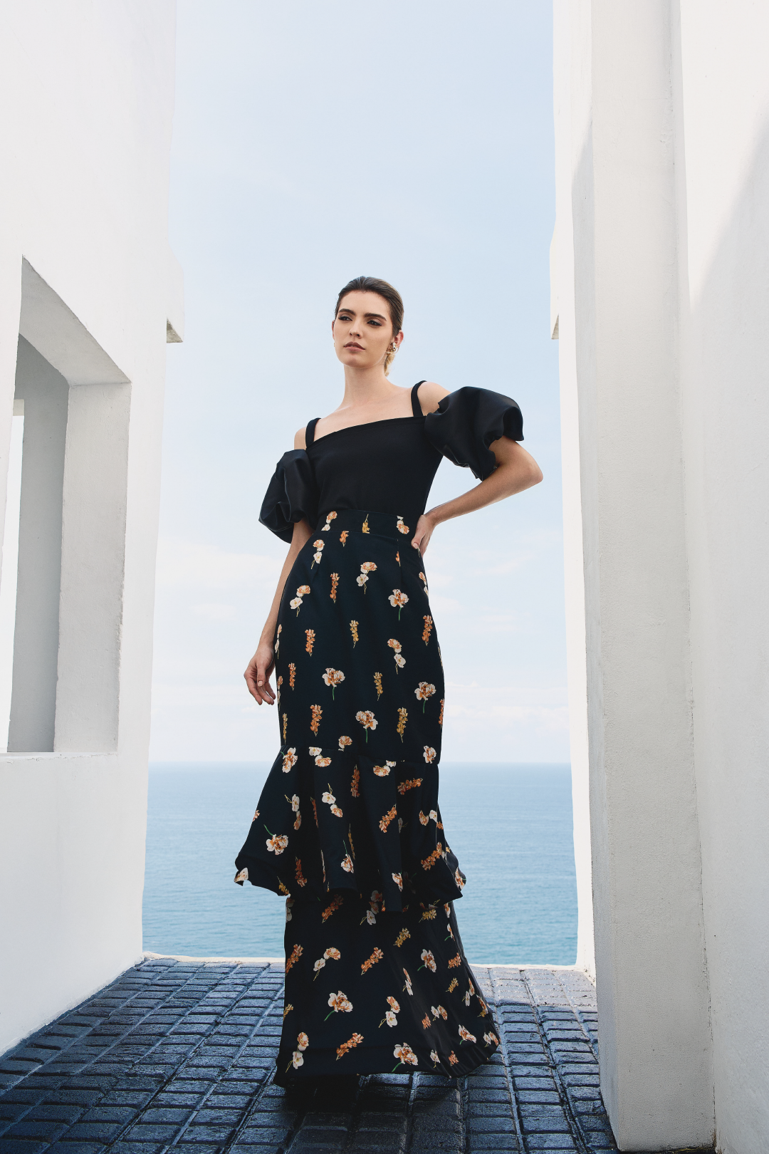 A model wearing black top with puffy sleeves by Monica Arguedas