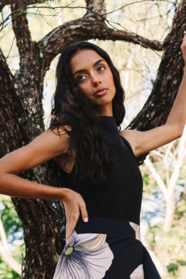 A model wearing a halter neck black bodysuit by Monica Arguedas.