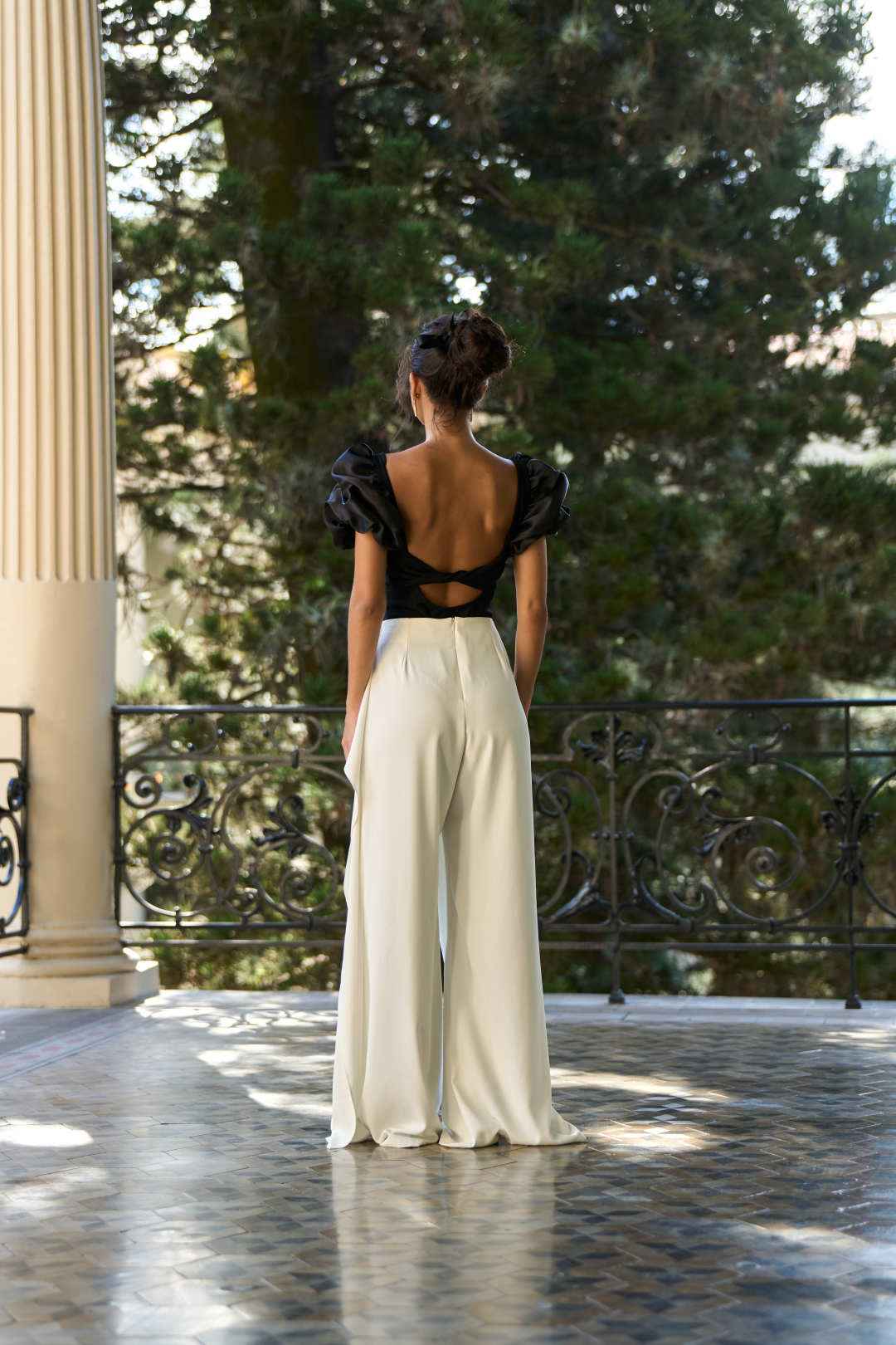 A model wearing white flowy pants by Monica Arguedas
