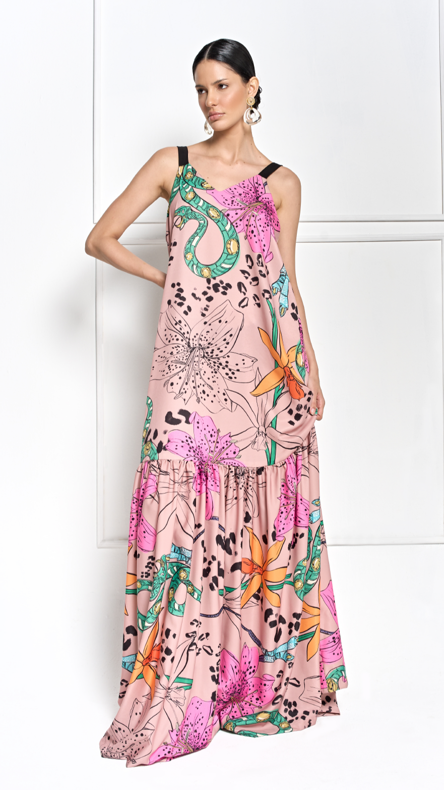 A model wearing a long nude dress with floral print by Monica Arguedas.