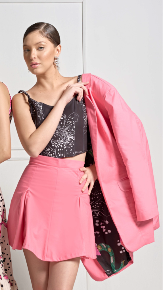 A model wearing a black corset with a white floral print by Monica Arguedas.