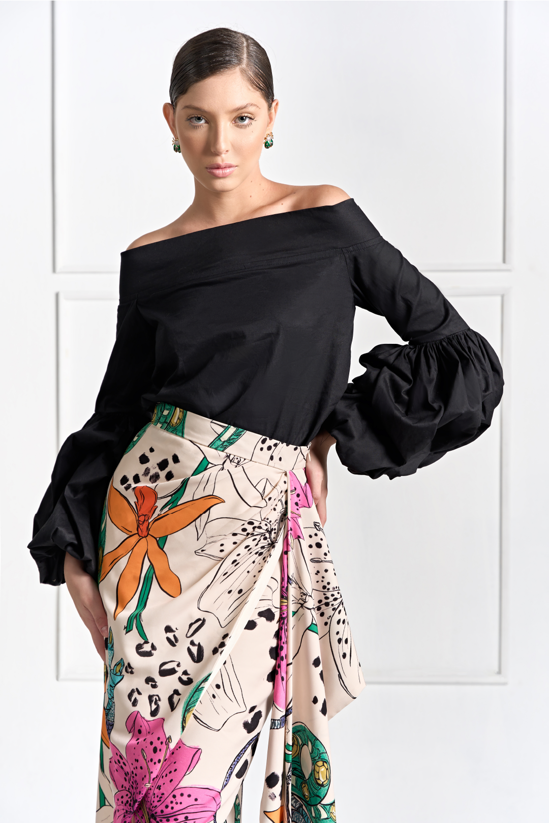 A model wearing creme skirt with ruffled slit on the side and floral print by Monica Arguedas.