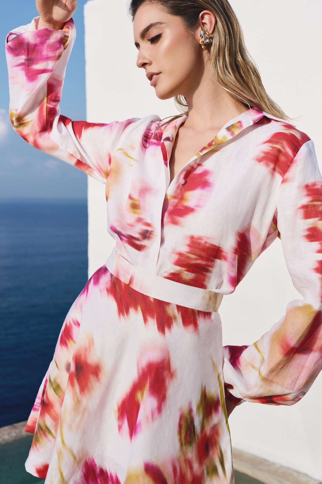 A model wearing a long sleeve top with pink floral print by Monica Arguedas.