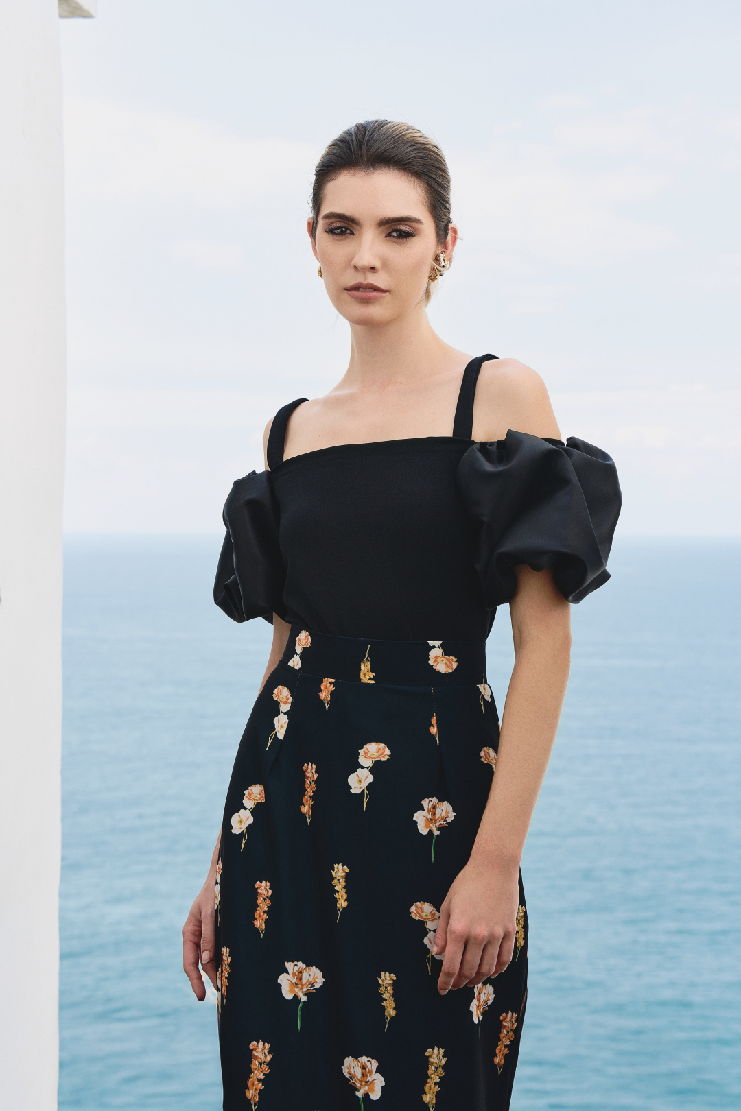 A model wearing black top with puffy sleeves by Monica Arguedas