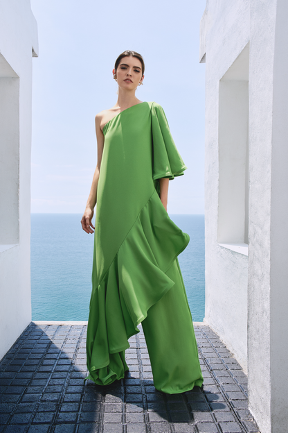 A model wearing a solid green flowy set by Monica Arguedas.