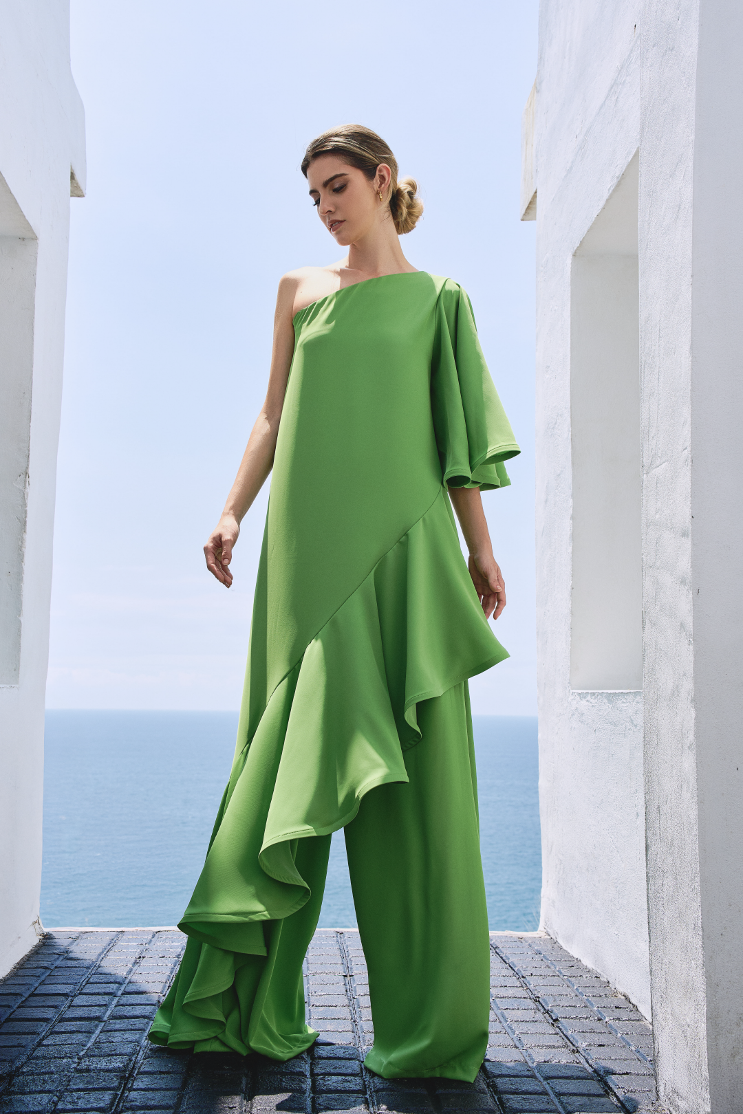 A model wearing solid green flowy pants by Monica Arguedas.