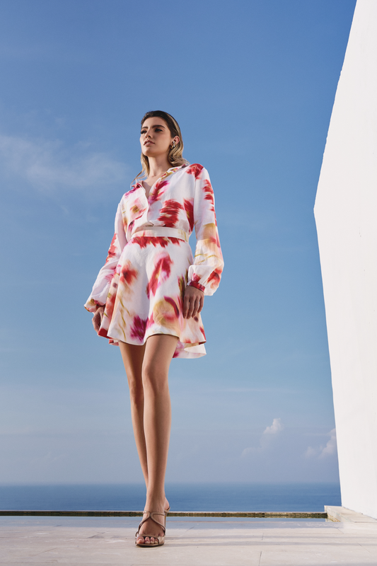 A model wearing a mini skirt with pink floral print by Monica Arguedas.