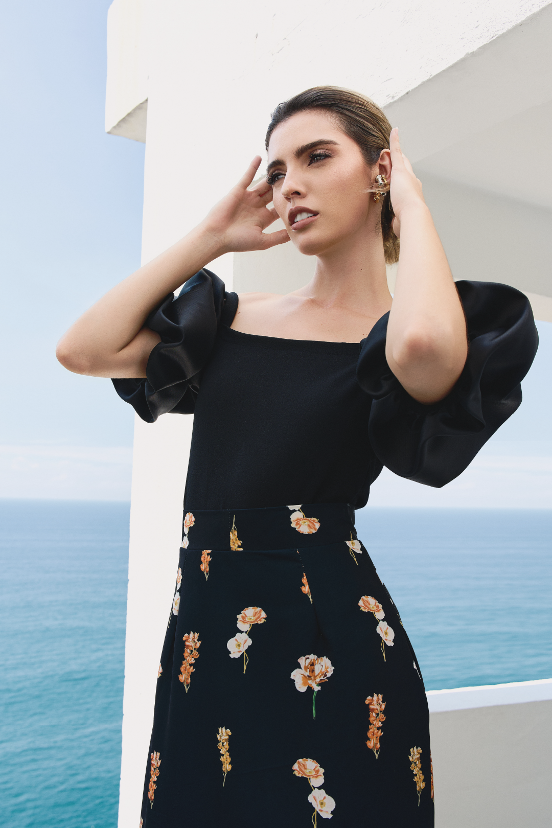 A model wearing black top with puffy sleeves by Monica Arguedas