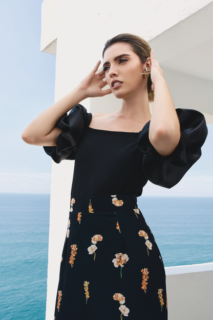A model wearing black top with puffy sleeves by Monica Arguedas