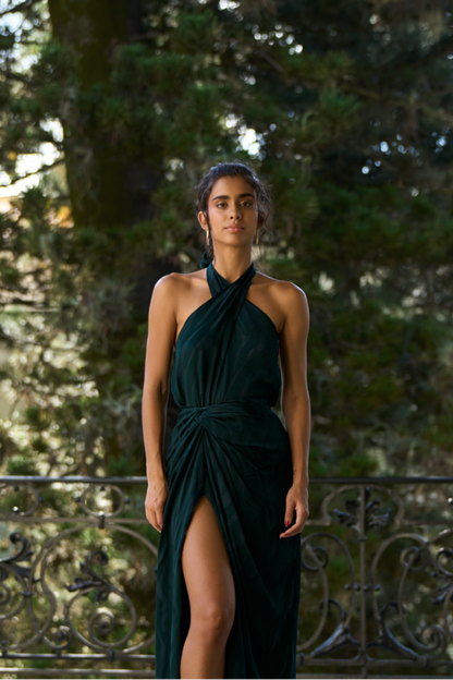 A model wearing a green halter top with an open back by Monica Arguedas.